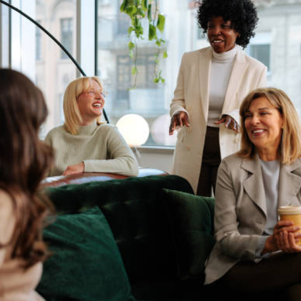 Women’s Initiative Network - photo of women in business casual attire socializing in a cafe